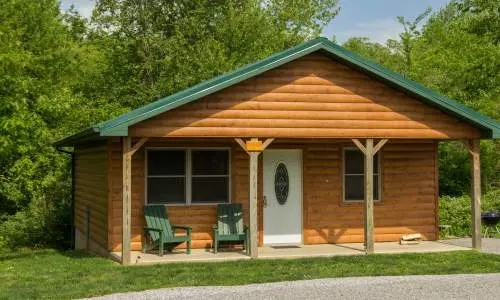 L'esterno di una baita in legno immersa nel verde