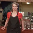 Una donna in piedi davanti al suo negozio