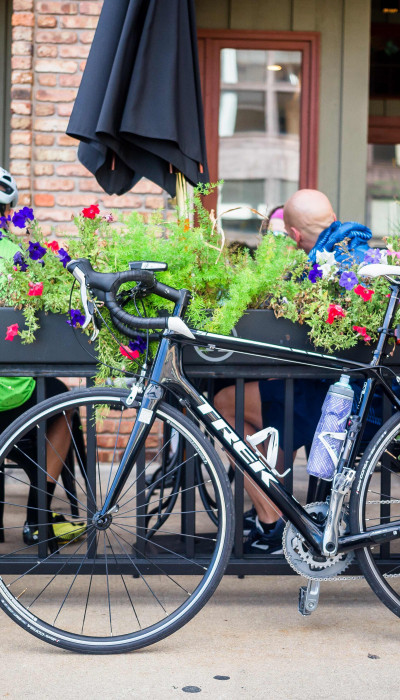 Ciclisti che prendono un caffè e le loro biciclette sono parcheggiate fuori dal bar.