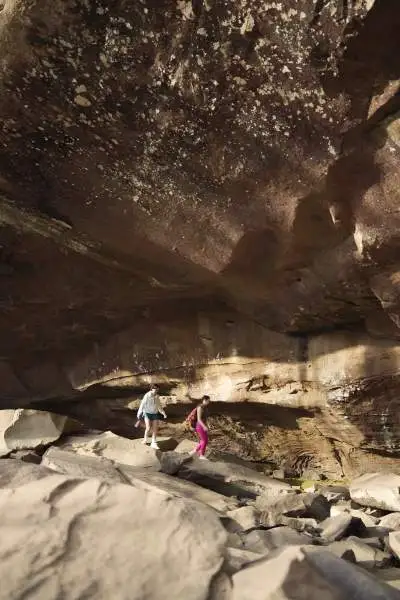 Persone che camminano in una grotta rocciosa