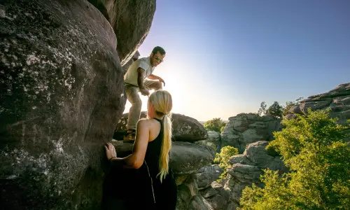 Due persone che si arrampicano su grandi rocce nella Shawnee National Forest