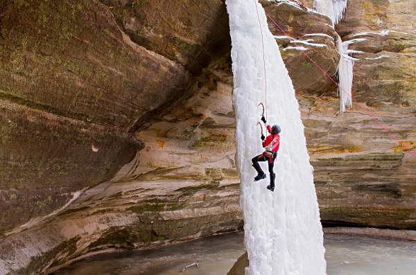 Persona che si arrampica su una cascata di ghiaccio